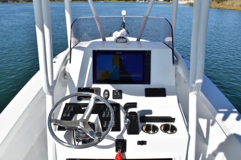 Slide: The Image of 2020 BlackJack 256 Coastal boat dashboard with steering wheel and navigation display. - 15