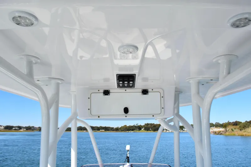 Slide: The Image of 2020 BlackJack 256 Coastal boat interior with overhead console and scenic water view. - 18