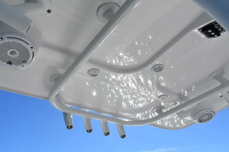 Slide: The Image of Underside view of a 2020 BlackJack 256 Coastal boat's canopy with speakers and rod holders. - 19