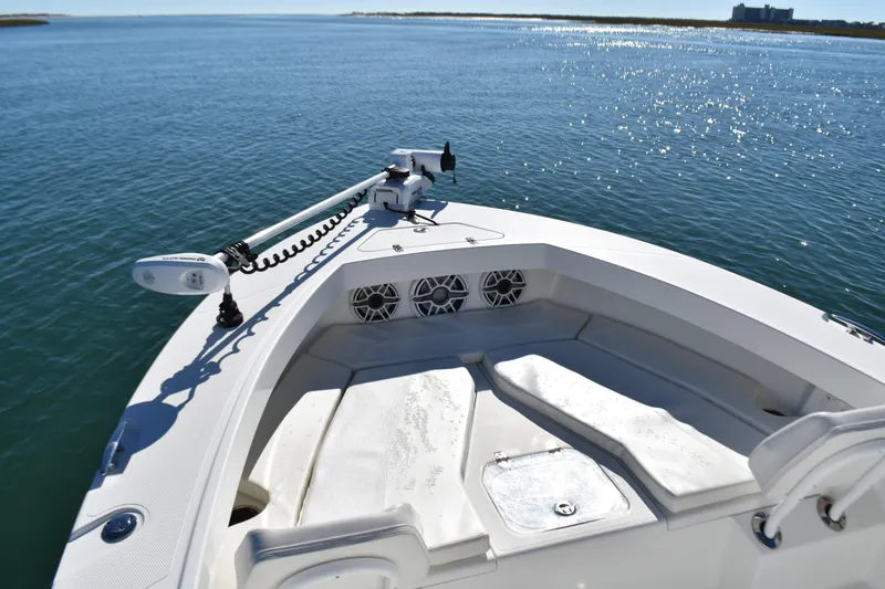 Slide: The Image of Bow of 2020 BlackJack 256 Coastal boat on calm water, featuring seating and speakers. - 9