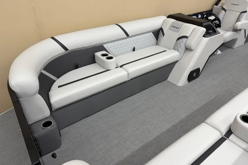 Slide: The Image of 2025 Crest Classic 240 boat interior with sleek gray and white seating and cup holders. - 4
