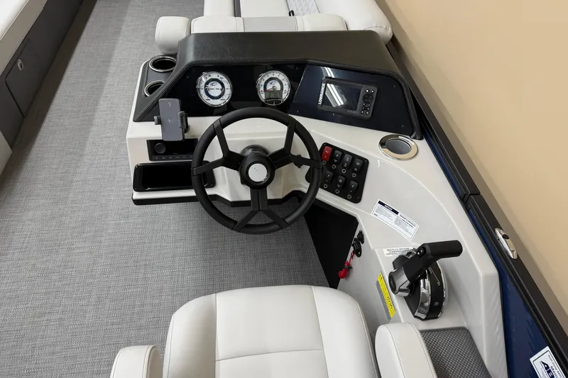 Slide: The Image of Steering console of 2025 Crest Classic 240 boat with modern controls and gauges. - 7