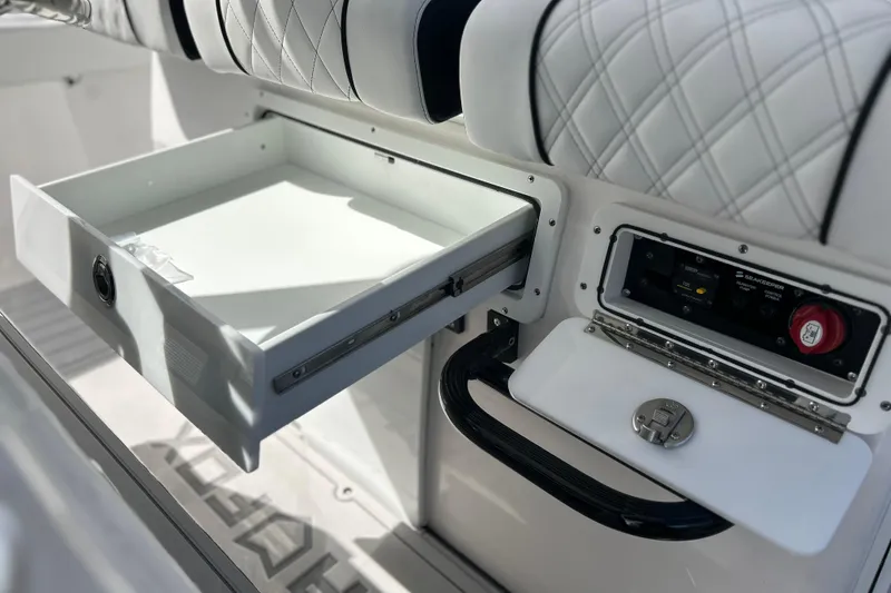 Slide: The Image of 2026 Sea Fox 368 Commander interior with open storage drawer and control panel. - 17