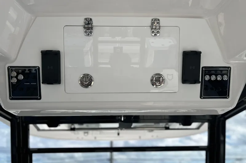 Slide: The Image of Control panel of 2026 Sea Fox 368 Commander boat, featuring switches and storage compartment. - 28