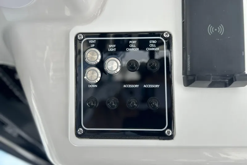 Slide: The Image of Control panel on 2026 Sea Fox 368 Commander boat with various switches and chargers. - 30