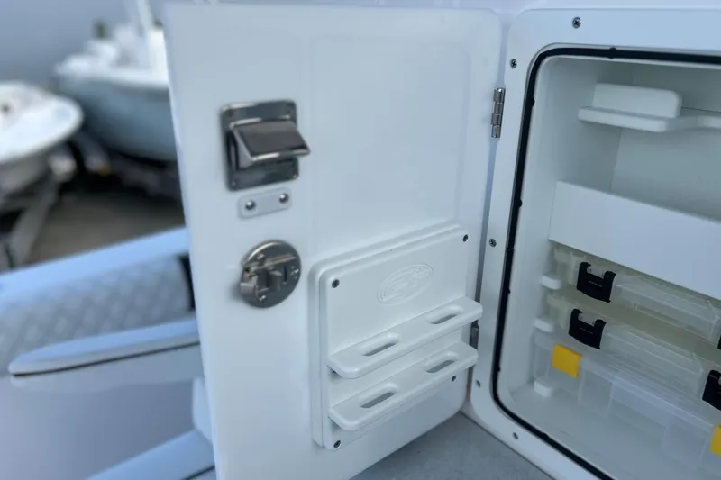 Slide: The Image of 2026 Sea Fox 368 Commander storage compartment with organized tackle boxes and secure latch. - 41
