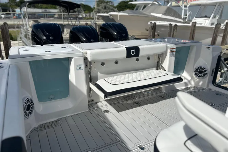 Slide: The Image of 2026 Sea Fox 368 Commander boat interior with seating and triple outboard engines. - 45