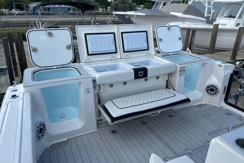 Slide: The Image of 2026 Sea Fox 368 Commander boat deck with storage compartments and seating. - 48