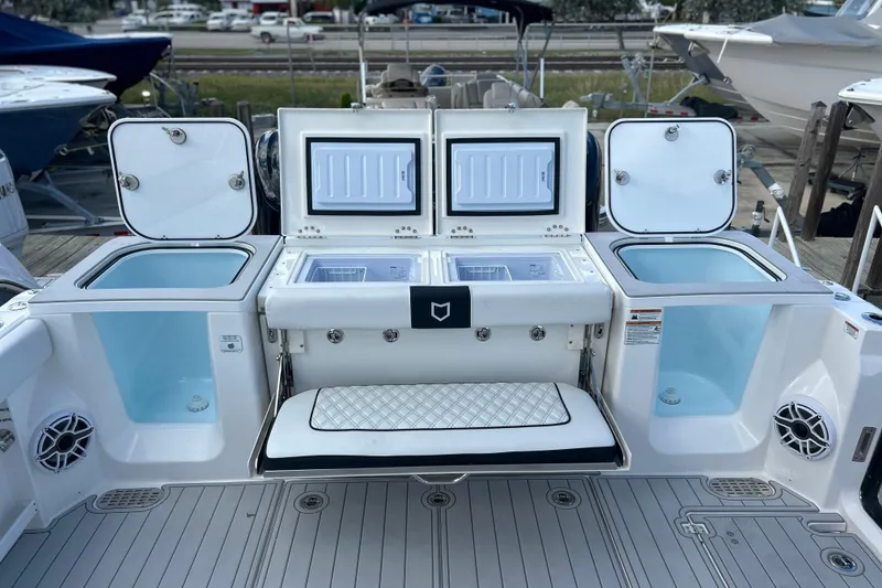 Slide: The Image of 2026 Sea Fox 368 Commander boat deck with storage compartments and seating. - 49