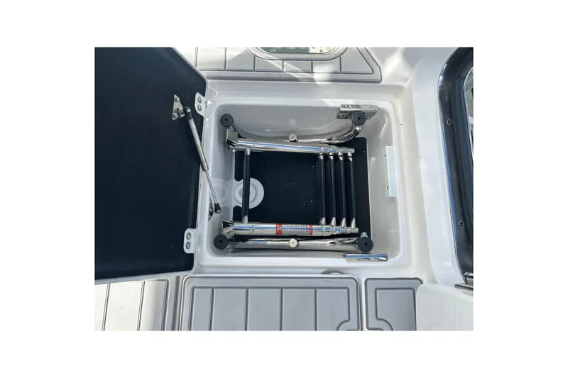 Slide: The Image of 2026 Sea Fox 368 Commander boat ladder compartment, open with stainless steel ladder. - 59