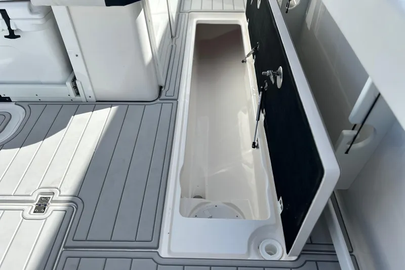 Slide: The Image of 2026 Sea Fox 368 Commander boat storage compartment with open lid, showcasing interior space. - 63