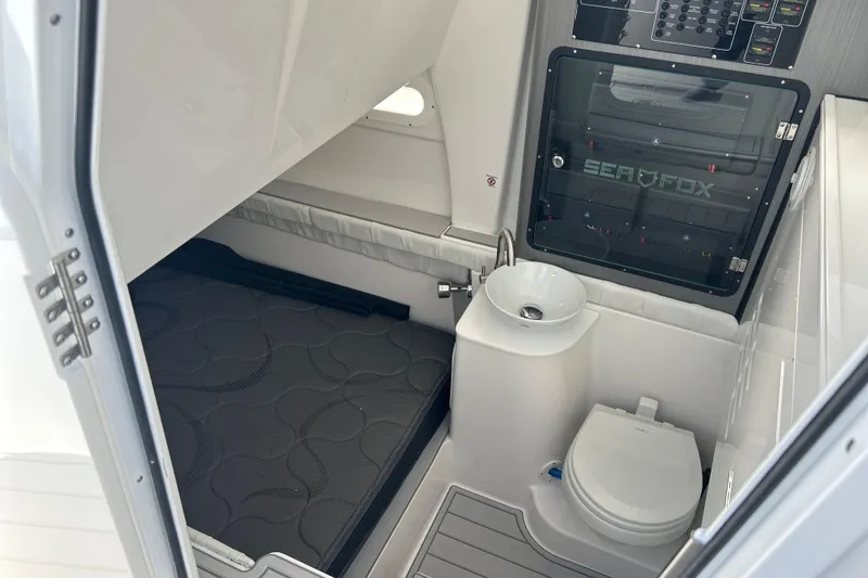 Slide: The Image of Interior of 2026 Sea Fox 368 Commander boat with compact bathroom and sleeping area. - 65