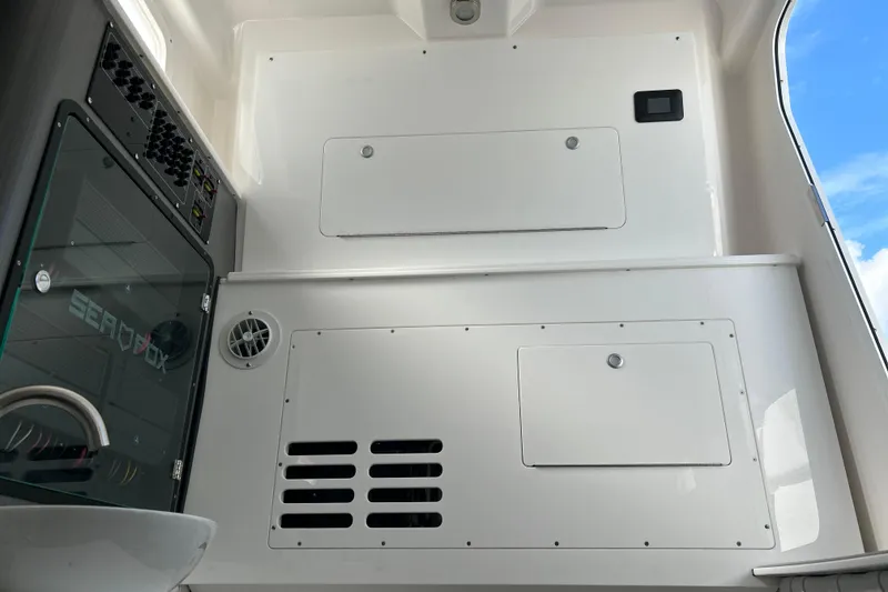 Slide: The Image of Interior view of 2026 Sea Fox 368 Commander boat, featuring control panels and storage compartments. - 68