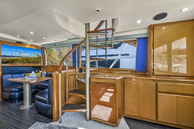 Slide: The Image of Luxurious interior of 1999 Viking 58 Convertible yacht with spiral staircase and dining area. - 13