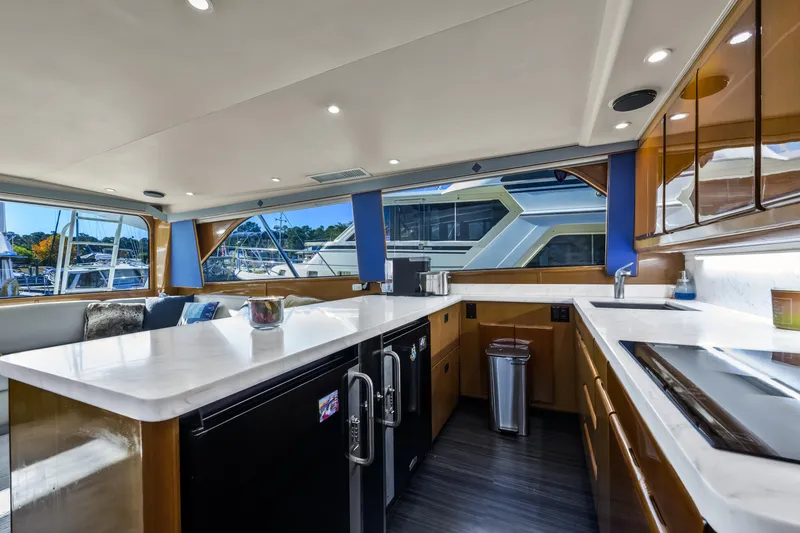 Slide: The Image of Luxurious interior of a 1999 Viking 58 Convertible yacht with modern kitchen amenities. - 17