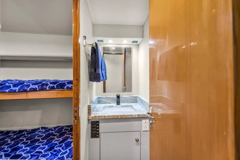 Slide: The Image of Interior of 1999 Viking 58 Convertible yacht with bunk beds and bathroom sink. - 20