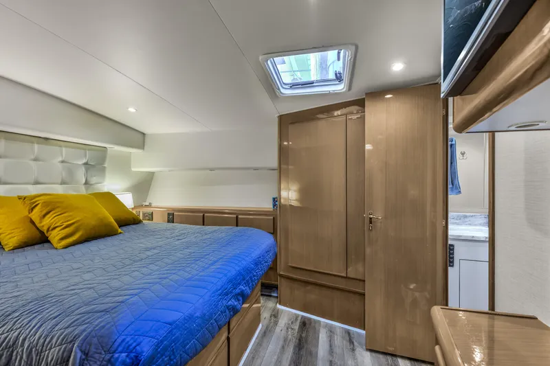 Slide: The Image of Luxurious bedroom interior of 1999 Viking 58 Convertible yacht with modern design. - 24