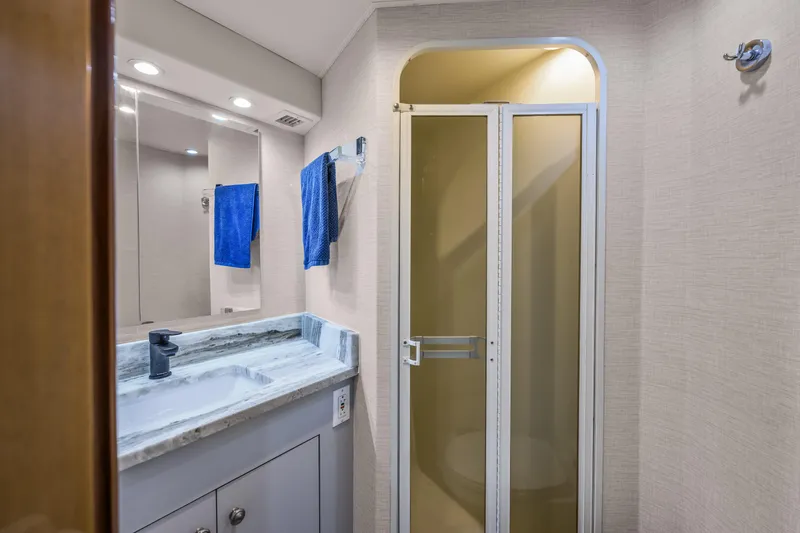 Slide: The Image of Bathroom interior of 1999 Viking 58 Convertible yacht with shower and marble sink. - 31