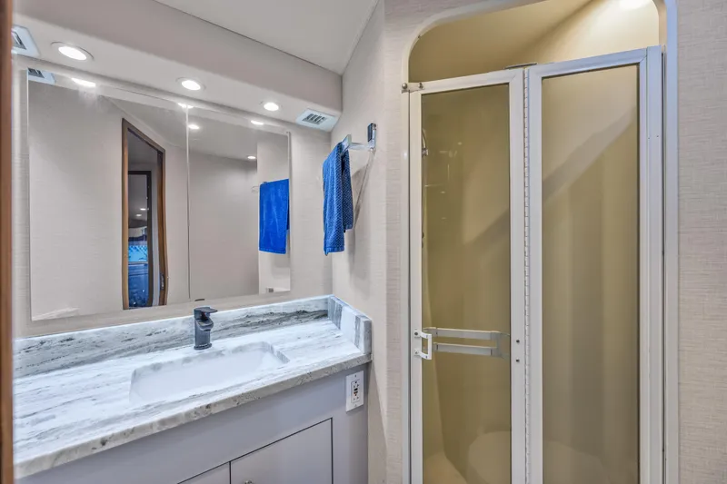 Slide: The Image of Luxurious bathroom in 1999 Viking 58 Convertible yacht with marble countertop and shower. - 32