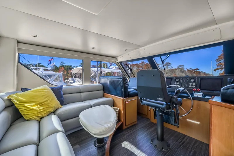 Slide: The Image of Interior of 1999 Viking 58 Convertible yacht with helm and seating area. - 33
