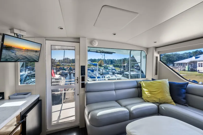 Slide: The Image of Luxurious interior of 1999 Viking 58 Convertible yacht with marina view. - 34