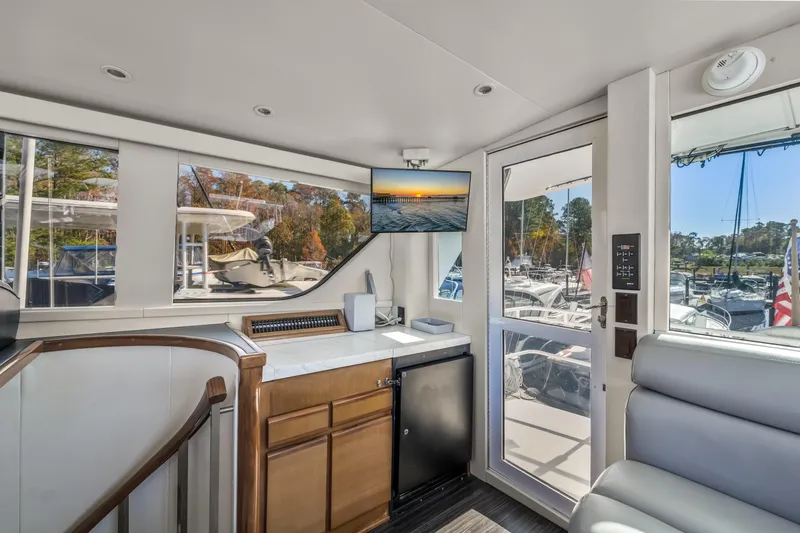 Slide: The Image of Interior of 1999 Viking 58 Convertible yacht with modern amenities and marina view. - 35