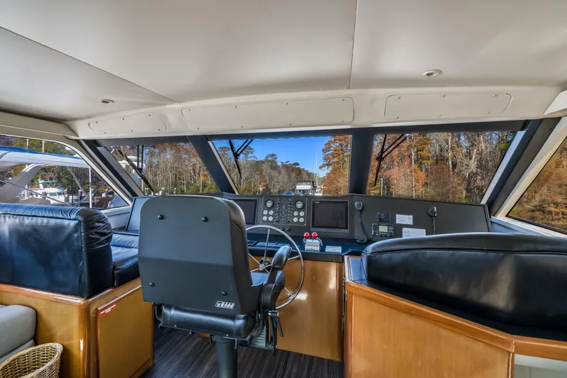 Slide: The Image of Interior view of 1999 Viking 58 Convertible yacht cockpit with steering wheel and navigation equipment. - 36