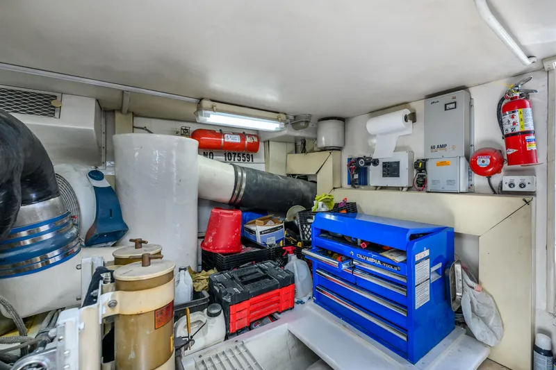 Slide: The Image of Engine room of 1999 Viking 58 Convertible with tools and equipment. - 38