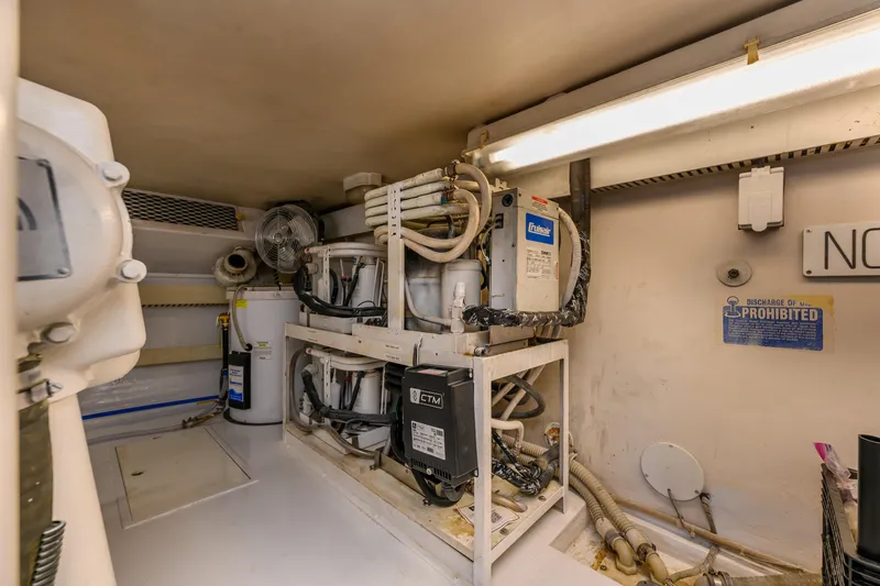 Slide: The Image of Engine room of 1999 Viking 58 Convertible yacht with mechanical equipment and piping. - 40