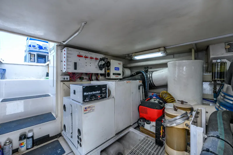 Slide: The Image of Engine room of 1999 Viking 58 Convertible yacht with Marine GenSet and control panels. - 41