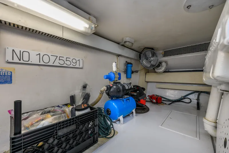 Slide: The Image of Engine room of 1999 Viking 58 Convertible with equipment and storage. - 42