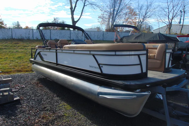 The Image of 2026 Godfrey Sweetwater 2486 QS iMPACT pontoon boat on display outdoors. - 1