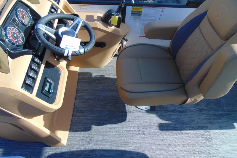 Slide: The Image of Captain's chair and dashboard of 2026 Godfrey Sweetwater 2486 QS iMPACT Package boat. - 11