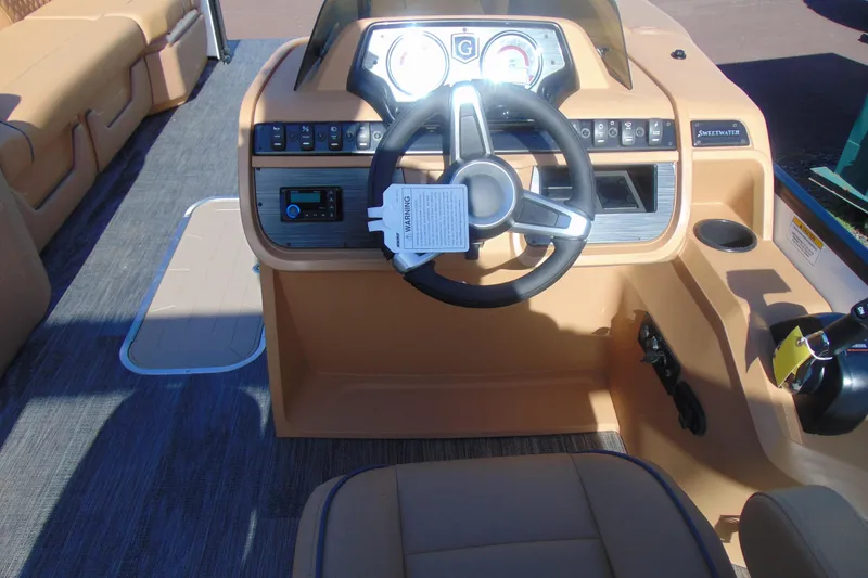 Slide: The Image of 2026 Godfrey Sweetwater 2486 QS iMPACT Package boat dashboard with steering wheel and controls. - 13