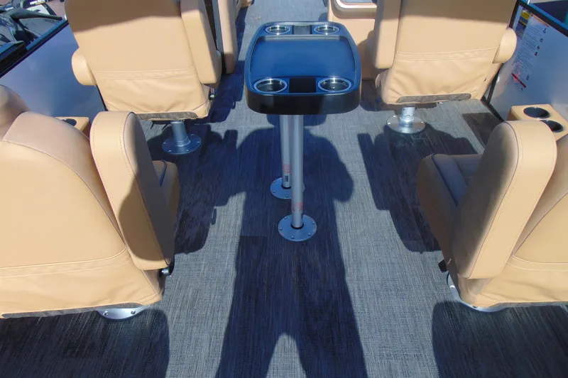 Slide: The Image of Interior of 2026 Godfrey Sweetwater 2486 QS iMPACT, featuring beige seating and a central table. - 16