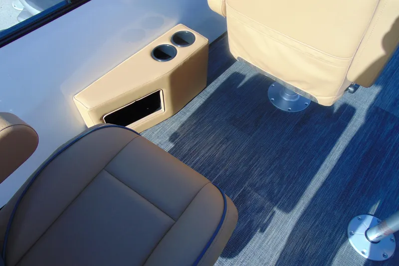 Slide: The Image of Interior of 2026 Godfrey Sweetwater 2486 QS iMPACT, featuring tan seating and cup holders. - 17