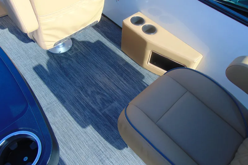 Slide: The Image of Interior of 2026 Godfrey Sweetwater 2486 QS iMPACT, featuring beige seating and cup holders. - 18