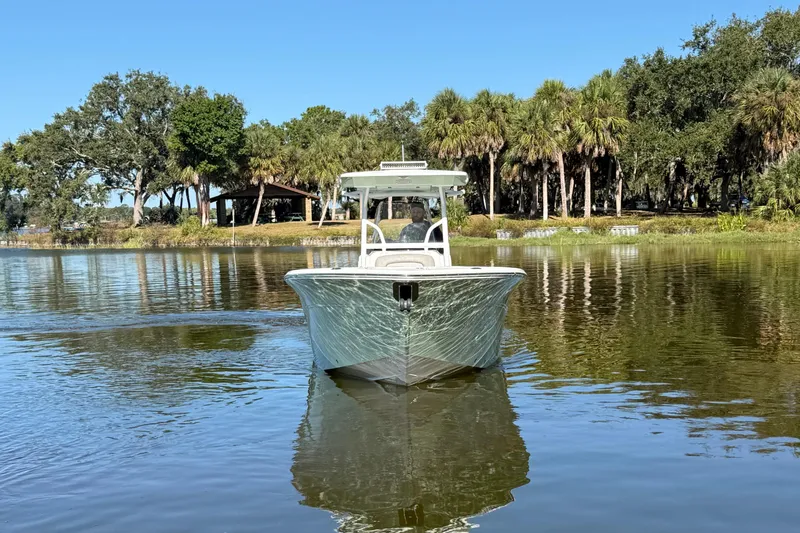 Slide: The Image of 2021 Sea Fox 268 Commander boat on a calm lake with lush trees in the background. - 11