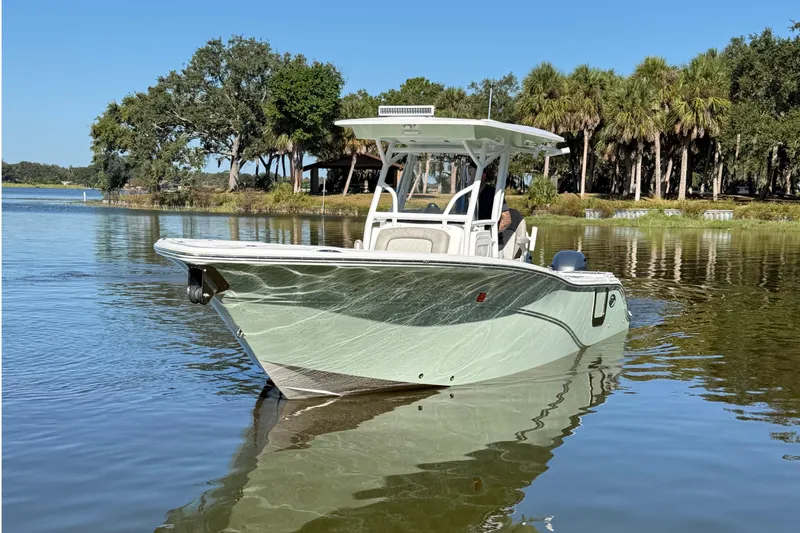 Slide: The Image of 2021 Sea Fox 268 Commander boat on calm water, surrounded by trees. - 12