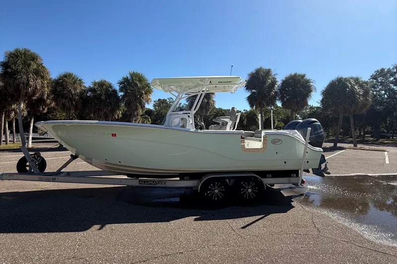 Slide: The Image of 2021 Sea Fox 268 Commander boat on trailer, parked near palm trees. - 18