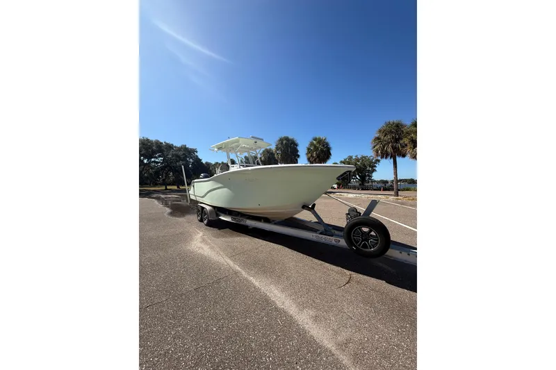 Slide: The Image of 2021 Sea Fox 268 Commander boat on trailer under clear blue sky. - 22