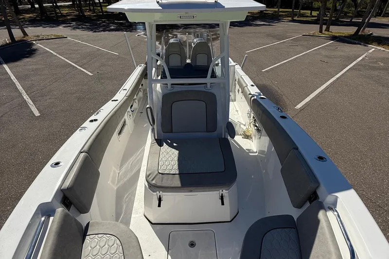 Slide: The Image of 2021 Sea Fox 268 Commander boat interior with seating and console in a parking lot. - 28
