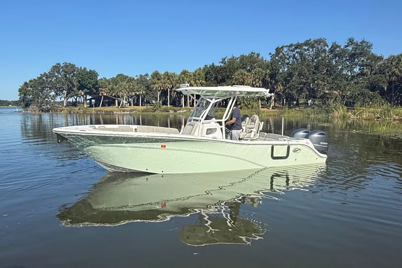 Slide: The Image of 2021 Sea Fox 268 Commander boat on calm water, surrounded by lush greenery. - 3