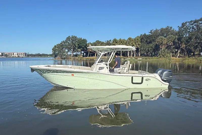 Slide: The Image of 2021 Sea Fox 268 Commander boat on calm water, surrounded by trees. - 4