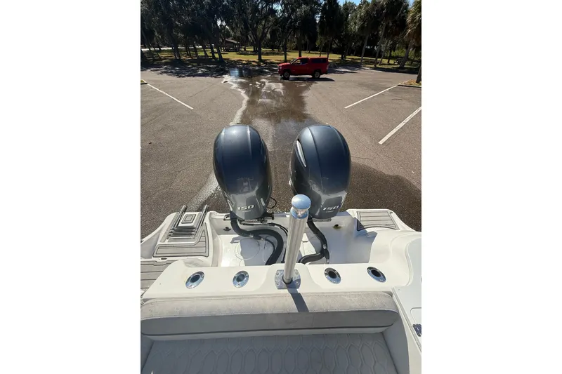Slide: The Image of 2021 Sea Fox 268 Commander boat with dual outboard engines in a parking lot. - 43