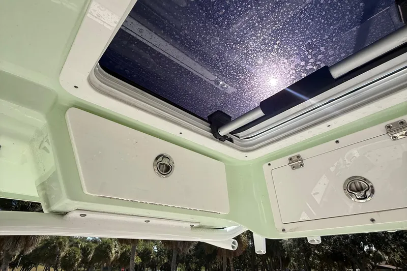 Slide: The Image of Interior view of a 2021 Sea Fox 268 Commander boat, featuring storage compartments and a sunroof. - 44