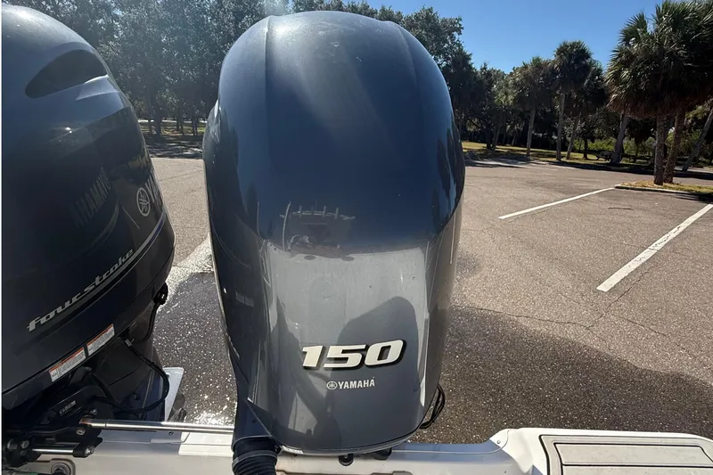 Slide: The Image of Yamaha 150 outboard motor on a 2021 Sea Fox 268 Commander boat in a sunny parking lot. - 46