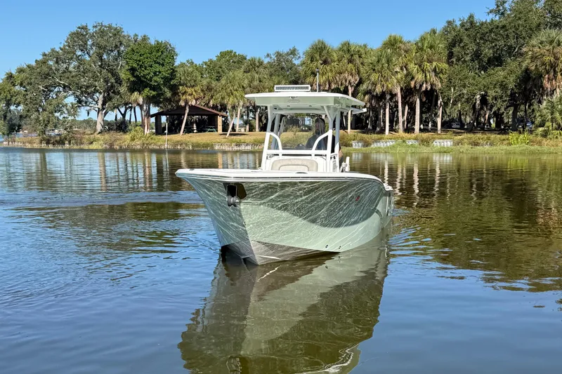 Slide: The Image of 2021 Sea Fox 268 Commander boat on calm water with trees in the background. - 9