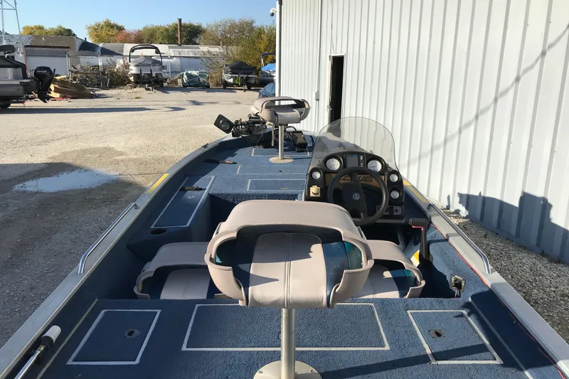 Slide: The Image of 1997 Lowe Bass Striker 170 boat interior with steering console and seating. - 10