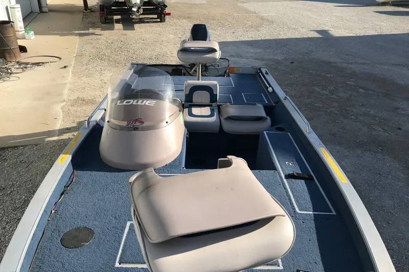 Slide: The Image of 1997 Lowe Bass Striker 170 boat interior with seating and console. - 11